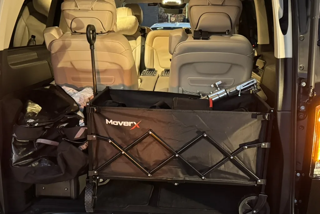 Mercedes-Benz V-Class boot loaded with a folding trolley, a kit bag and equipment for a production
