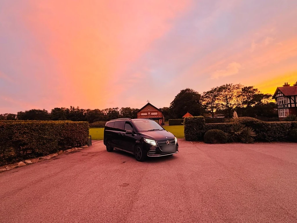 Mercedes V-Class golf transport waiting on the forecourt at Royal Lytham and St Annes at dusk