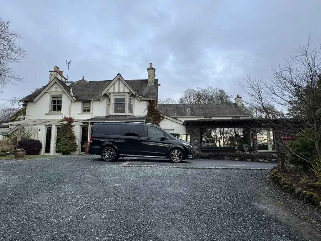 Multi-day chauffeur hire: a black Mercedes V-Class parked outside a hotel in Windermere