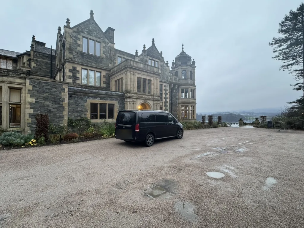 Private chauffeur tours: a black Mercedes-Benz V-Class outside a lakeside hotel near Windermere in the Lake District