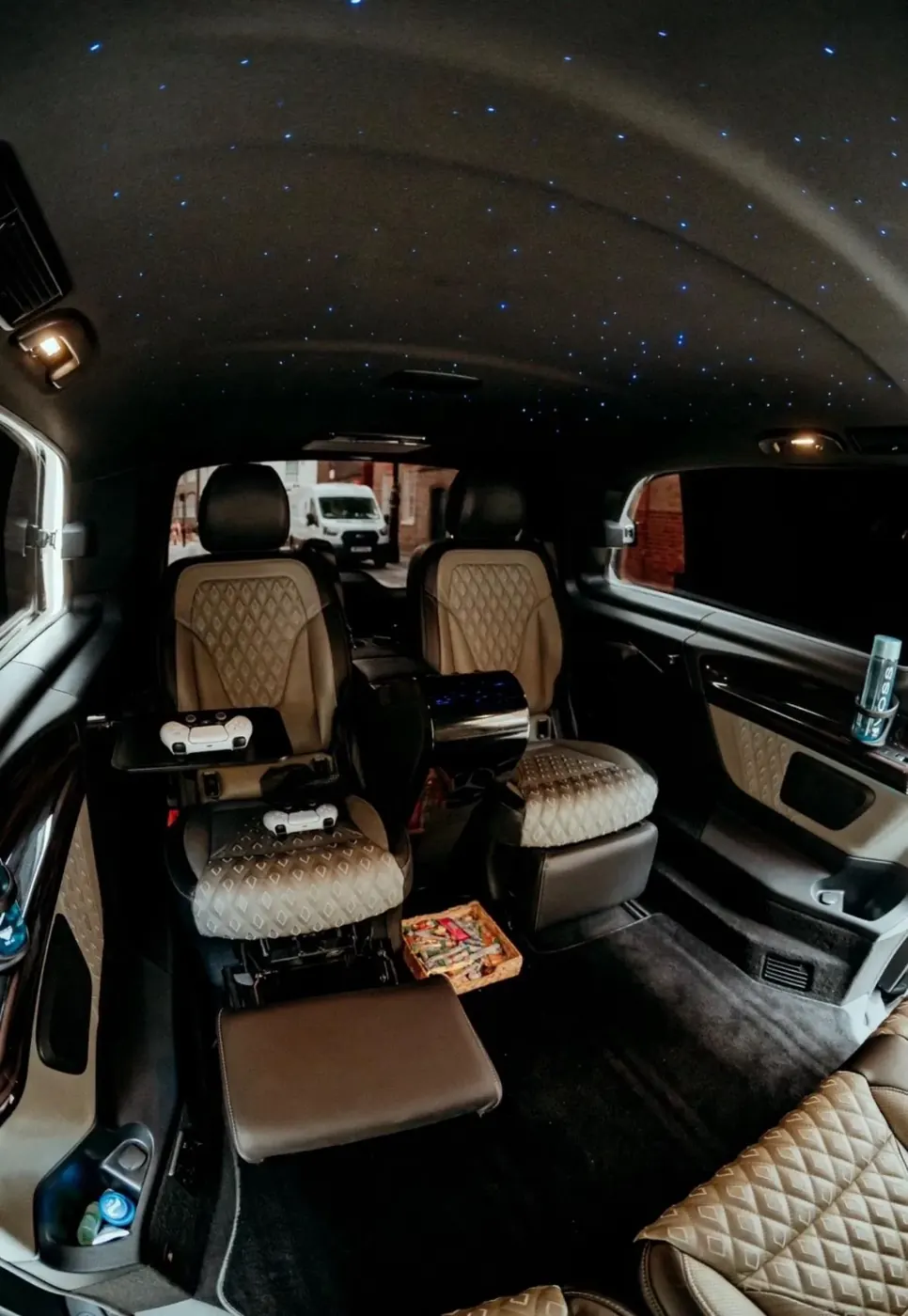 V-Class interior with quilted leather seats, games console controllers and starlight ceiling