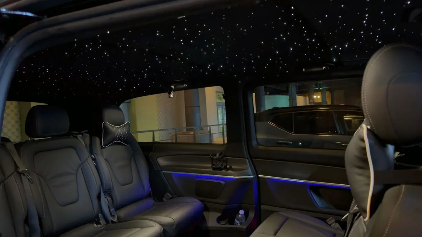 V-Class interior with starlight ceiling, black leather seats and blue ambient lighting