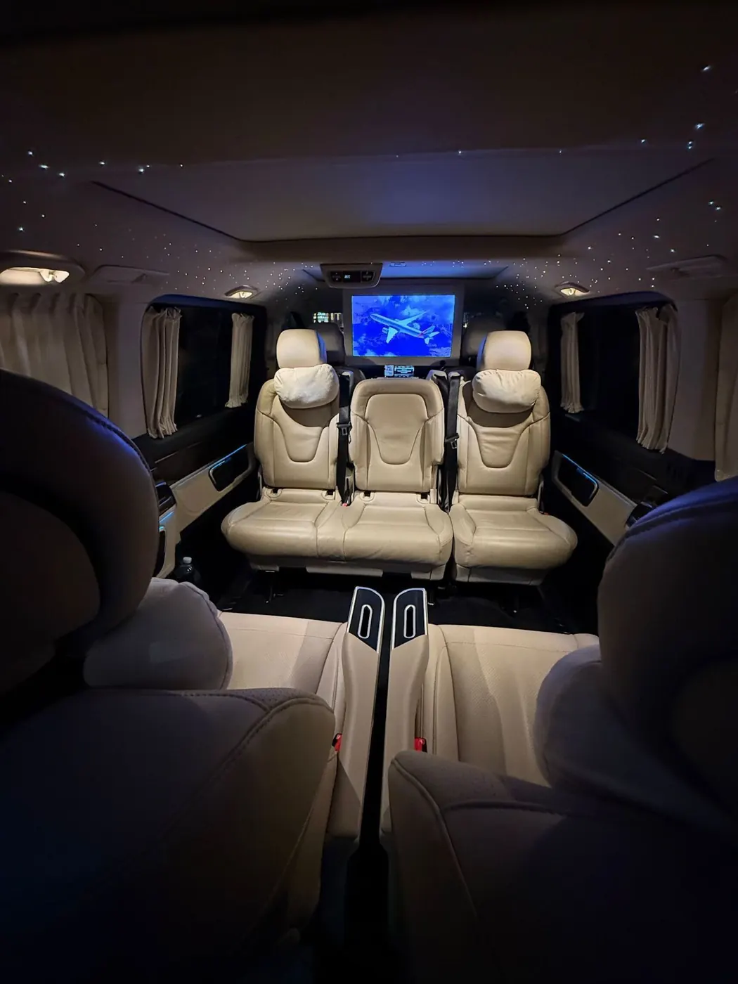 V-Class interior with cream leather seats, curtains, starlight ceiling and TV screen