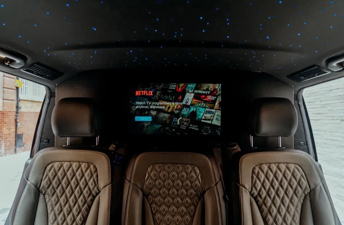 V-Class interior with quilted leather seats facing a large TV screen