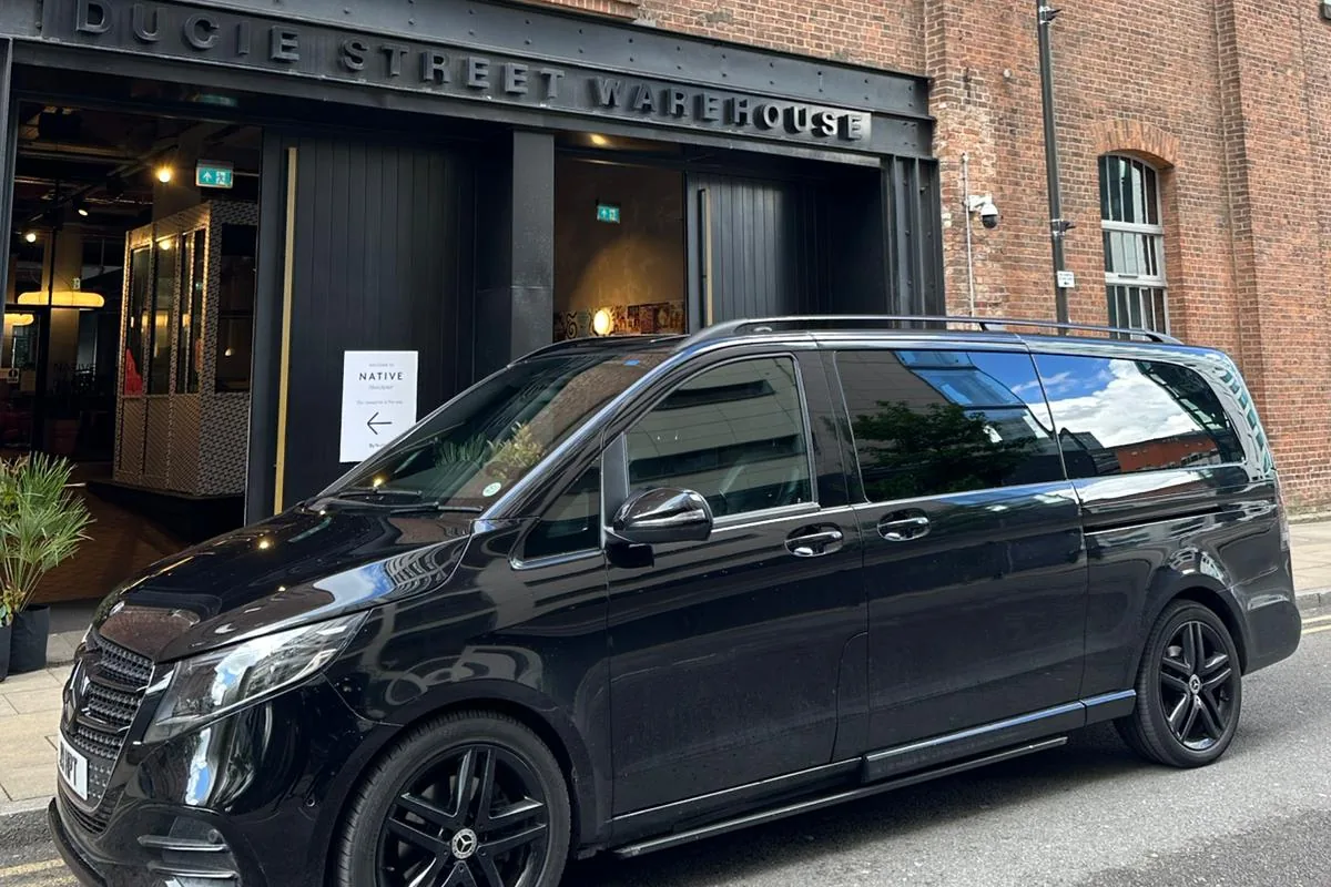 Black Mercedes-Benz V-Class chauffeur car outside the Ducie Street Warehouse hotel in Manchester