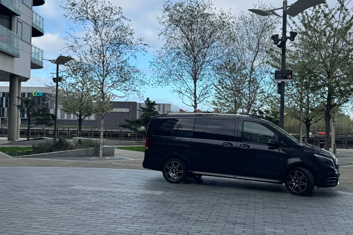 Black Mercedes-Benz V-Class chauffeur car in the square at MediaCity in Salford, Greater Manchester