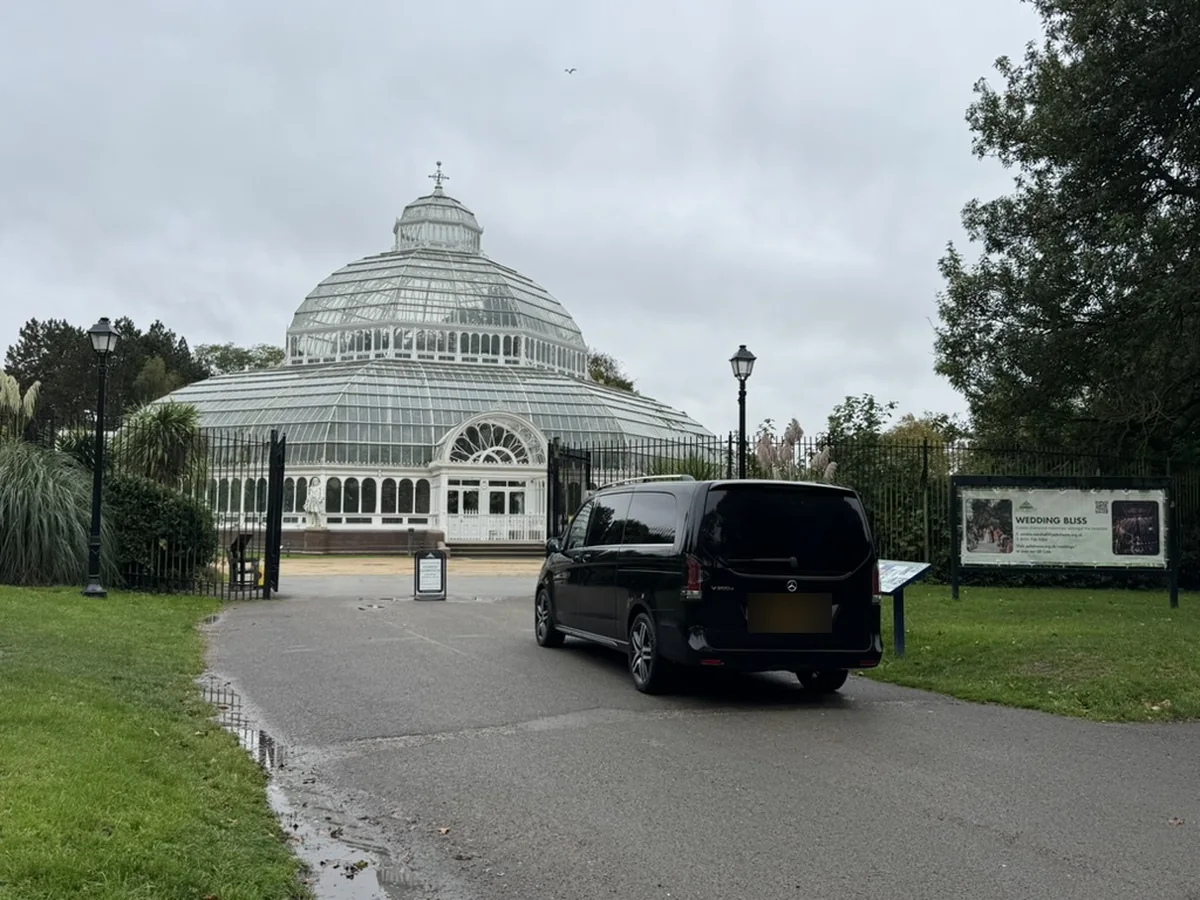 Black Mercedes-Benz V-Class wedding chauffeur car arriving at a park venue in the North West